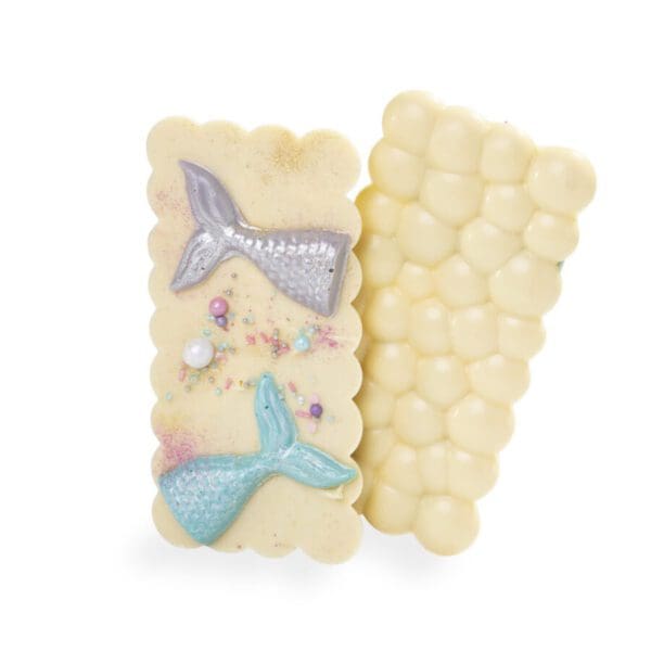 A White chocolate bar, inlaid with mermaid ttails and colourful sprinkles.