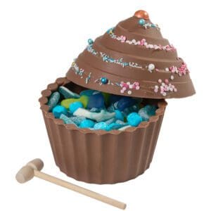 A gender reveal cake with blue pick and mix sweets. Bash open the chocolate cake to reveal the colour.