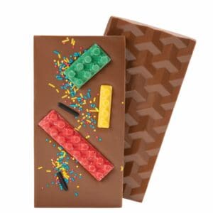 Have you ever wished you could build and eat at the same time? Well, now you can with our Lego Chocolate Bar! Made with our delicious creamy milk chocolate and decorated with edible white chocolate pieces shaped like Lego blocks, this bar is the perfect snack for the inner child in you. It’s like playing with your food, but in the best way possible. Plus, with the added bonus of colorful sprinkles, you can have a chocolatey building party in your mouth. So go ahead, take a bite and unleash your inner master builder! (Warning: may cause uncontrollable cravings for more!)
