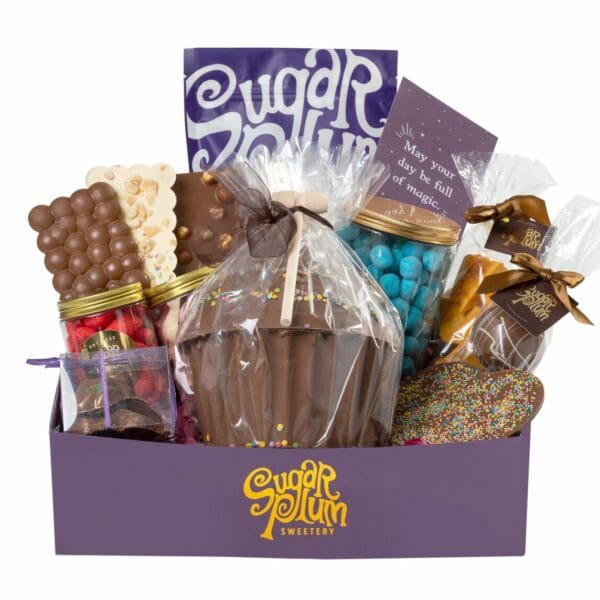 Deluxe Gift Hamper showcasing an array of chocolates, ribbon-wrapped gift box, a greeting card, and a selection of our bestselling treats