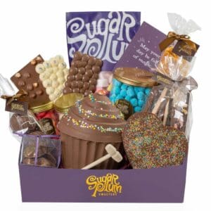 Ultimate Gift Hamper showcasing a lavish spread of chocolates, ribbon-tied gift box, a magical greeting card, and Master Chocolatiers' favorite selections.