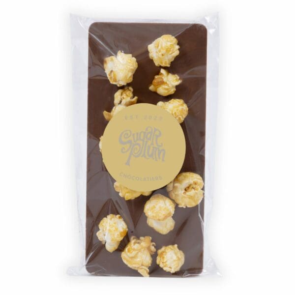 Introducing the ultimate movie night companion – our dreamy handmade Milk Chocolate Popcorn Bar! We took two of your favourite treats, smooshed them together, and voila – a crunchy, munchy, gooey, chewy masterpiece. Imagine biting into a creamy milk chocolate bar, only to be met with the satisfying crunch of caramel popcorn. It’s like a party in your mouth, and everyone’s invited. Perfect for those who can never decide between sweet or salty, our Popcorn Bar is the best of both worlds. Plus, it’s handmade with love straight from our Chocolate Factory, so you know it’s gotta be good. So, grab a bar (or five) and get ready for a flavour explosion that’ll make you scream… ACTION!