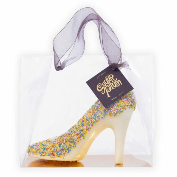 Elevate your sweet cravings with our handmade and decorated White Chocolate Heel, a delicious and stylish confection that’s sure to turn heads. Crafted from our premium quality white chocolate and moulded into the shape of a chic heel, this treat is as delightful to look at as it is to eat. But we didn’t stop there. Our creamy White Chocolate Heel is also adorned with a rainbow of colourful sprinkles, adding a playful touch of whimsy to this already delightful confection. The smooth and creamy white chocolate perfectly balances the crunch of the sprinkles, creating a heavenly taste experience that’s hard to resist.