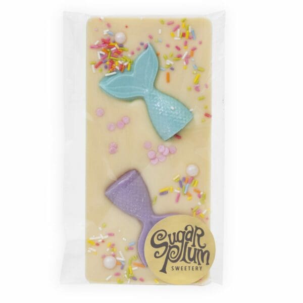 A White chocolate bar, inlaid with mermaid ttails and colourful sprinkles.