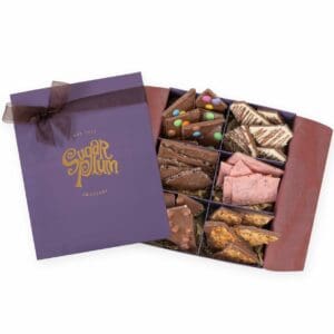 Deluxe Chocolate Barks Box containing six handmade chocolate slabs & barks, including Cookies & Cream, Coconut Dream, Whole Hazelnut, Dark Almond, Raspberry Ripple, and Florentine Favourite. Presented in an elegant box, it's an exquisite selection for the discerning chocolate lover.
