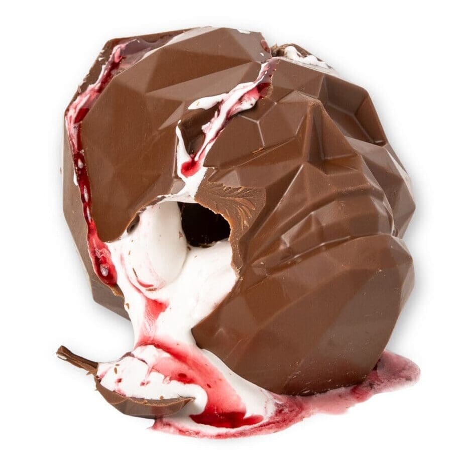 Halloween chocolate skull filled with fluffy marshmallow and raspberry sauce