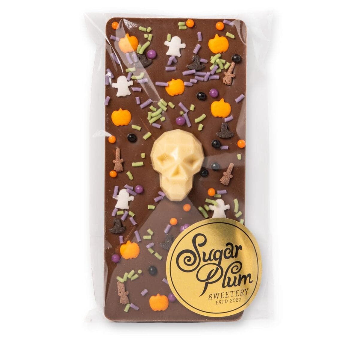 Halloween chocolate bar featuring a detailed white chocolate skull on milk chocolate with colourful spooky decorations