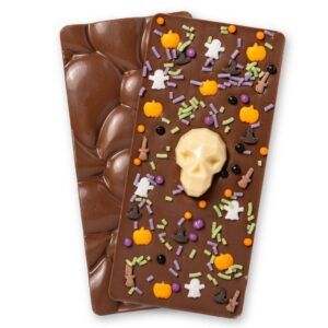 Sugar Plum Sweetery Halloween milk chocolate bar decorated with a white chocolate skull, orange pumpkins, ghosts, witches hats and Halloween sprinkles