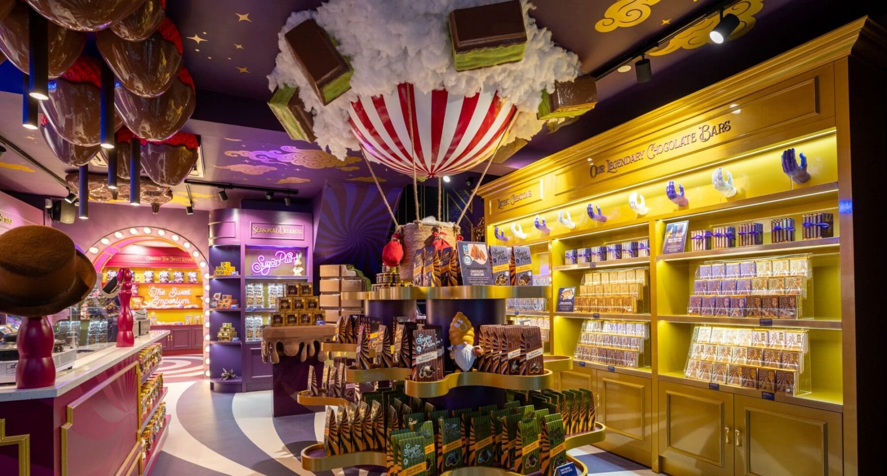 Chocolate bars on gold shelves under a hot-air balloon in the Cork shop